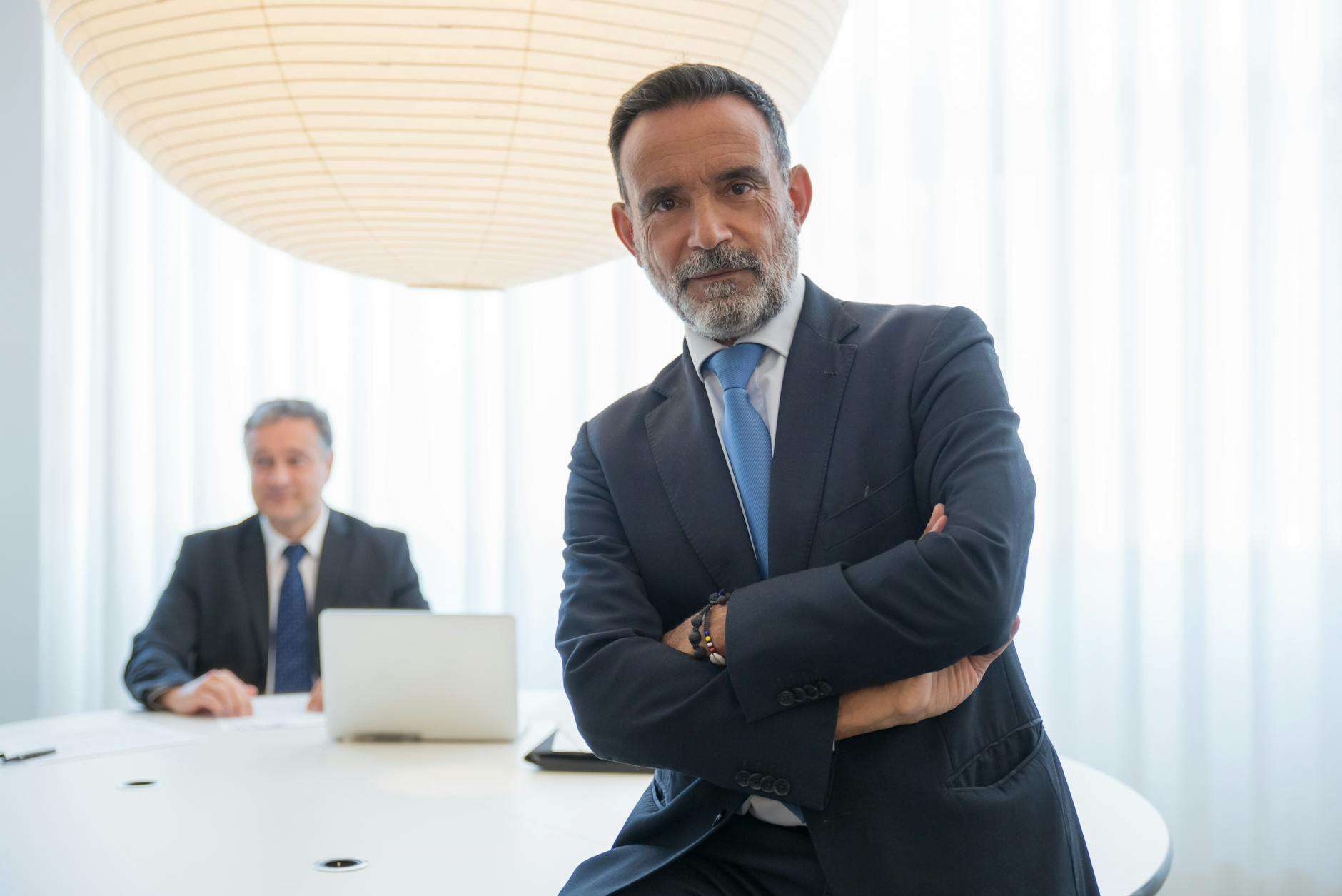 businessman in a suit with his arms crossed